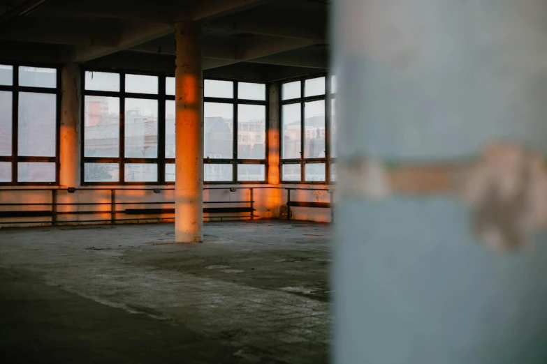 an empty warehouse with lots of windows in it