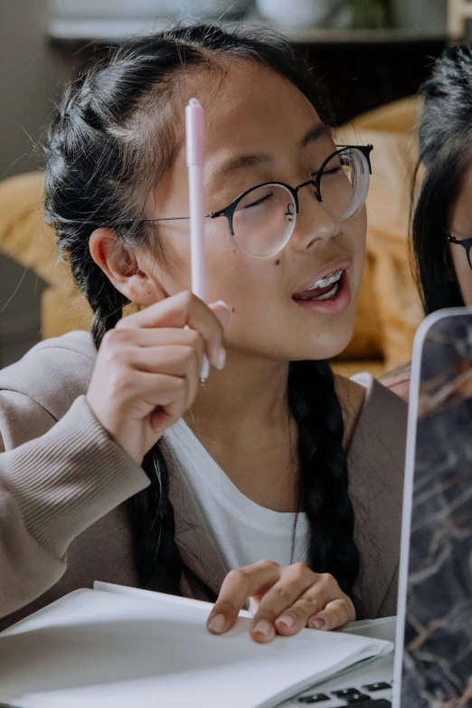 an asian woman using a laptop computer