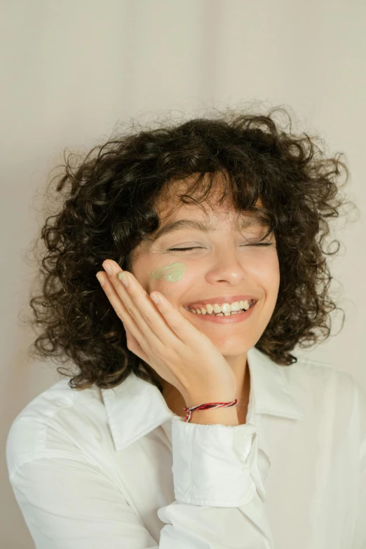 a young woman smiling with her hair blowing back