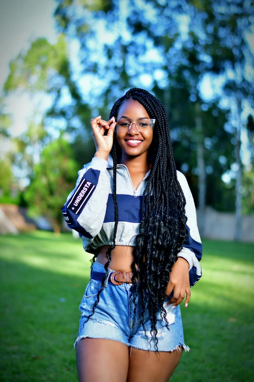 the young woman smiles and poses in the grass