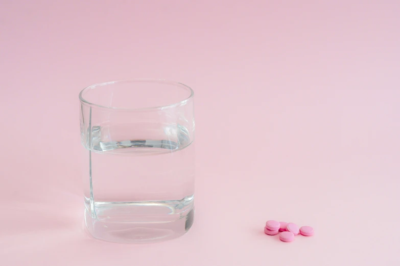 pills sitting on top of a glass of water