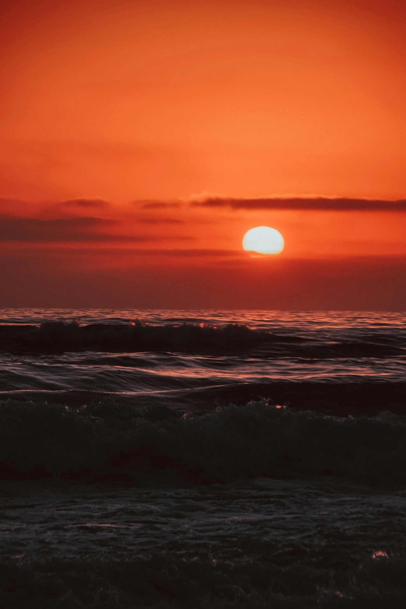 a sunset is shining over the ocean and waves