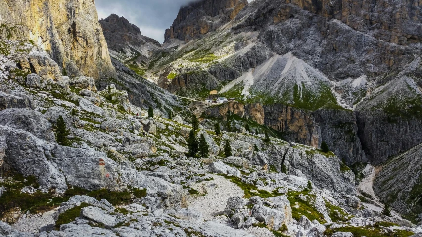 some very large rocks and small trees on the mountains