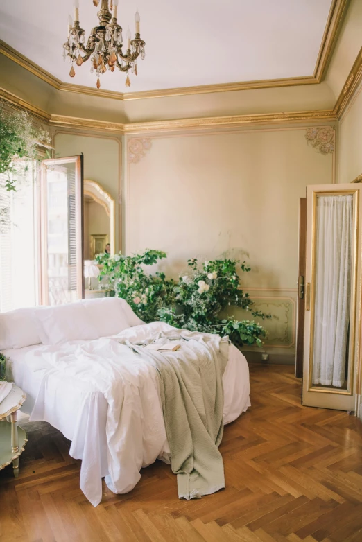 a white bed in a large room with windows