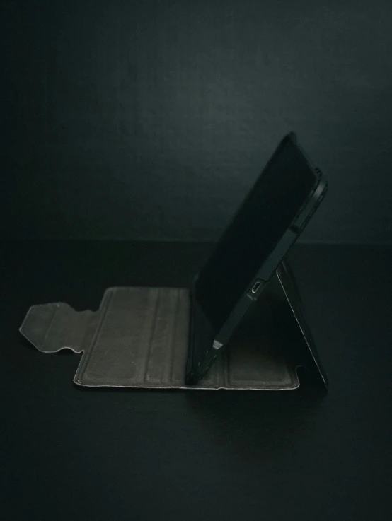 a black cell phone on top of a wallet