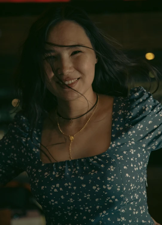 a close up of a woman with a necklace on her neck