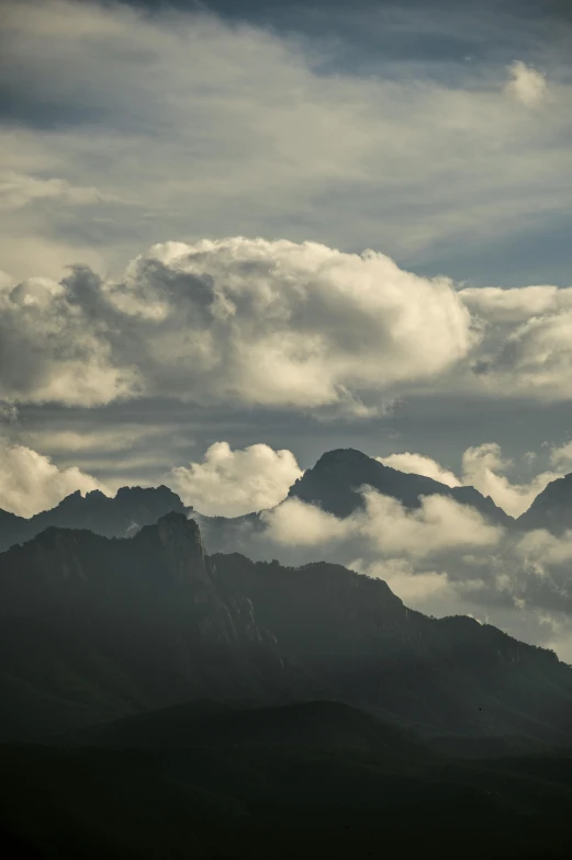 a view from the top of a mountain covered in clouds