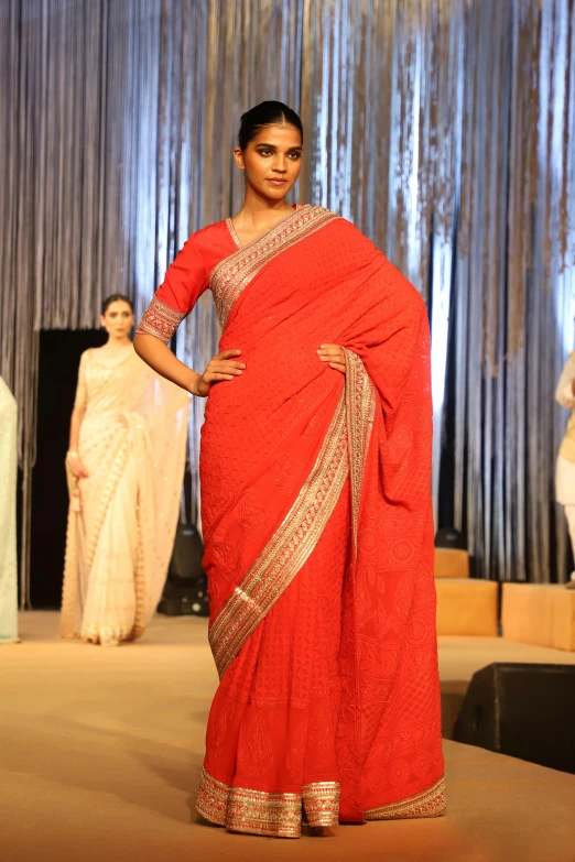 model in red saree, at fashion show