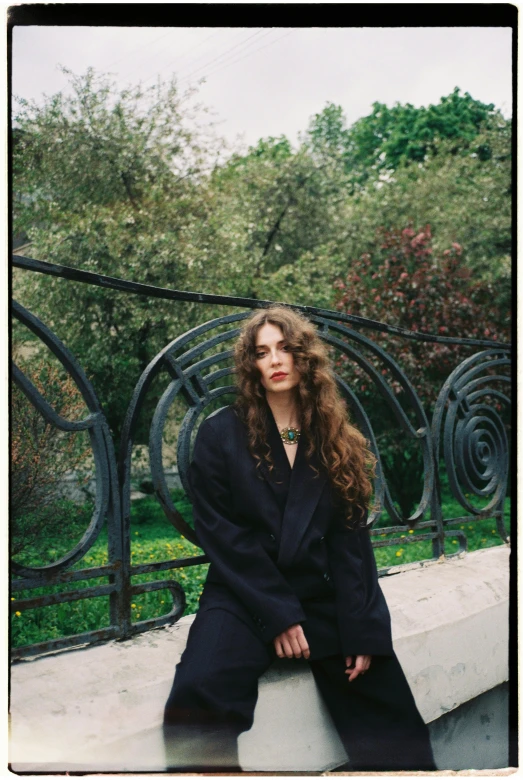 an image of a woman sitting on a wall