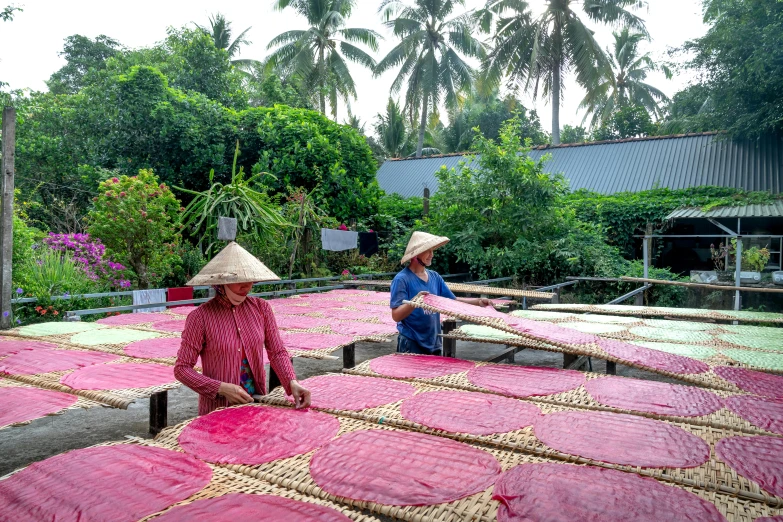 a man and woman sitting on top of large rectangular beds