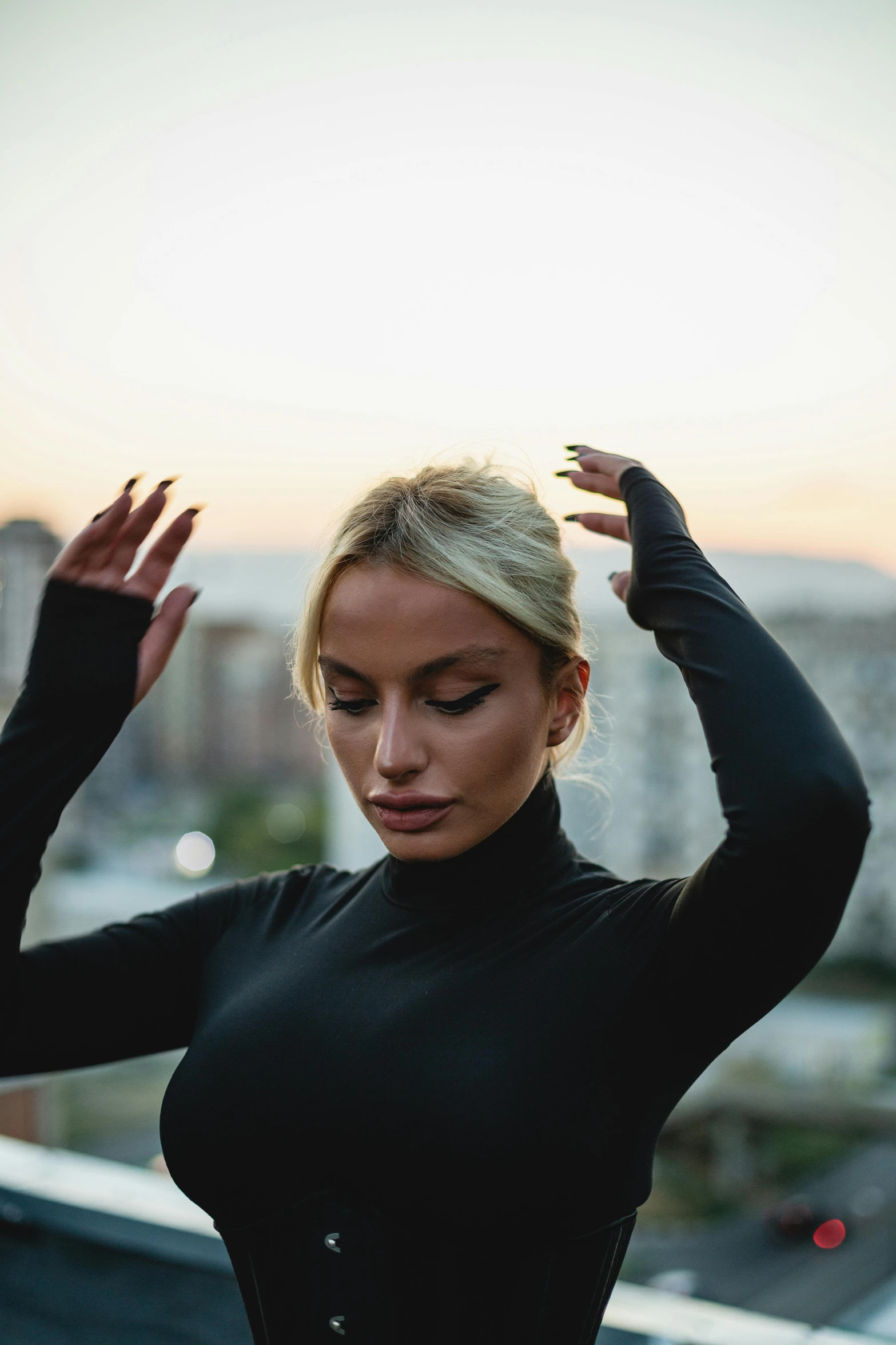 a young woman doing yoga on top of a building