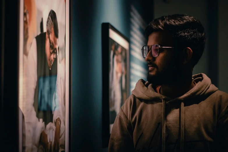 a man standing in front of a poster on a wall