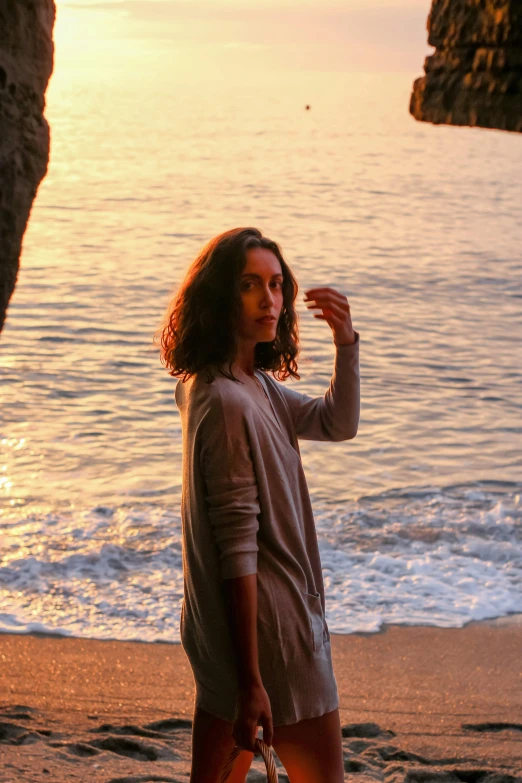 a woman on the beach with a suitcase