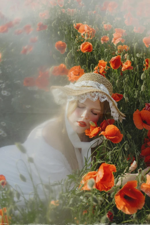 woman in white gown with hat in poppy field