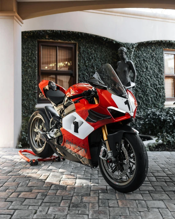 a red motorcycle is parked outside a house