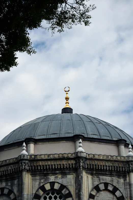 an ornate dome with a weather vein on top