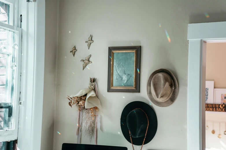 a hat, a picture and other decorations decorate the walls of a room