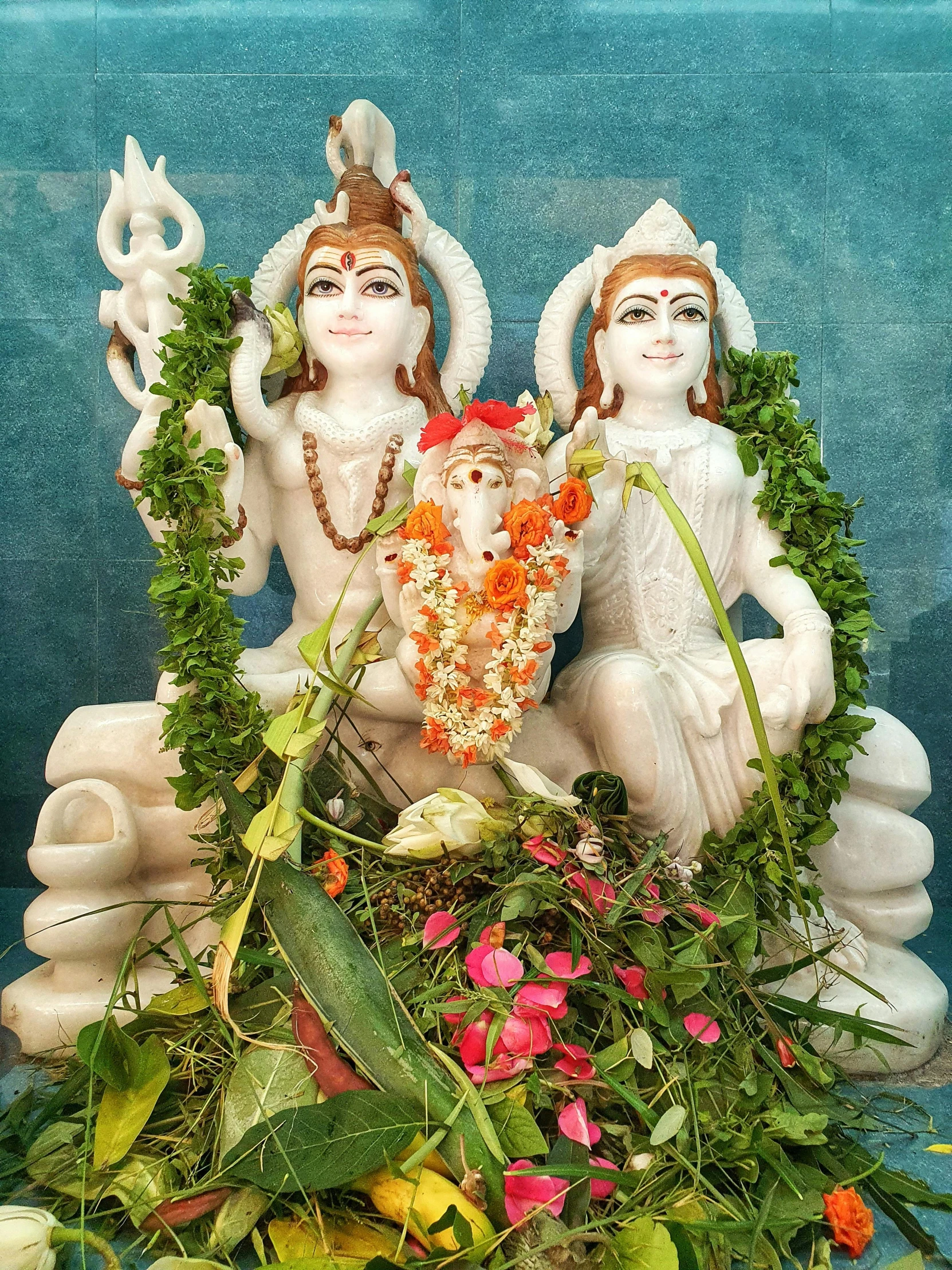 three people are sitting on top of some flowers