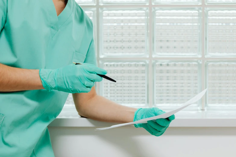 a surgeon with scissors  through some sheet