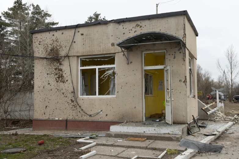 a rundown home with some broken doors and windows