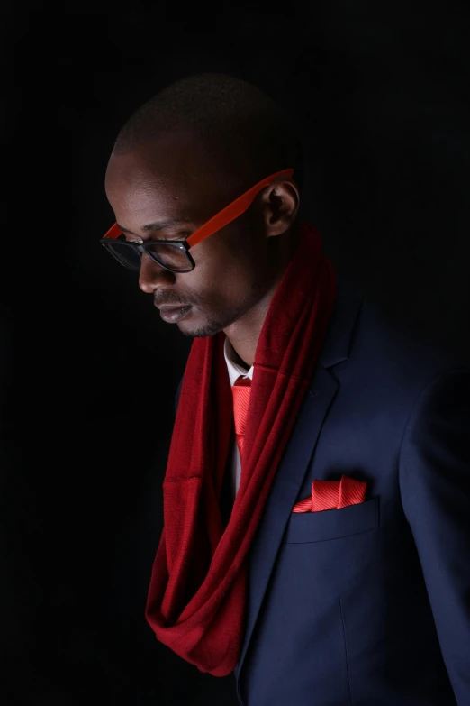 an african american man in a suit with a red scarf