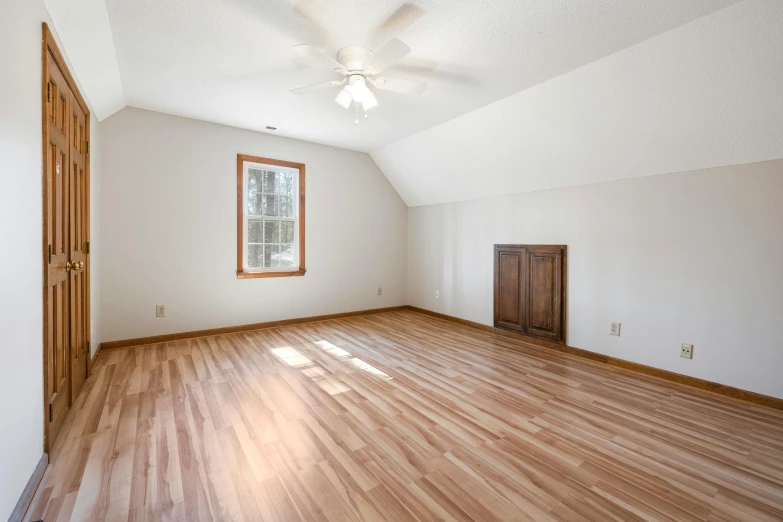 a room with hardwood flooring and a window in it