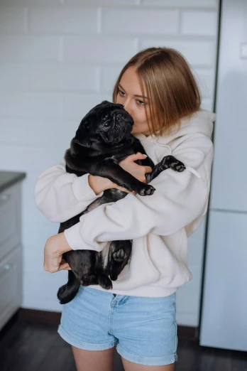 a woman with long hair holding her dog