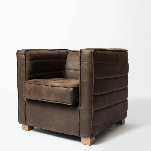 a brown leather armchair with wooden legs