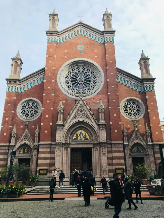 people standing in front of an ornate church