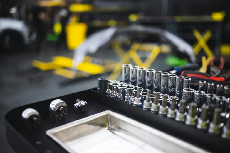 a group of different kinds of tools on a tool bench