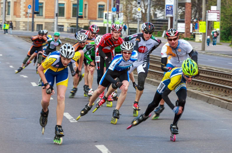 a bunch of people riding roller skates on a road