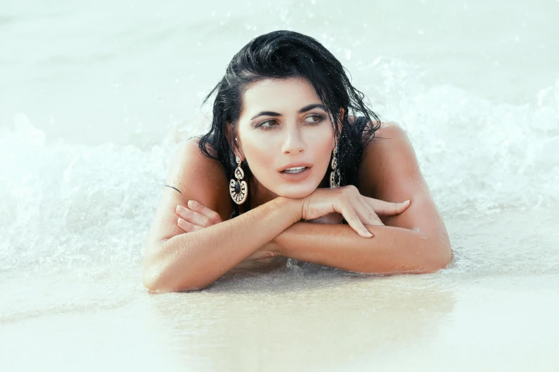 the woman is posing for a picture on the beach