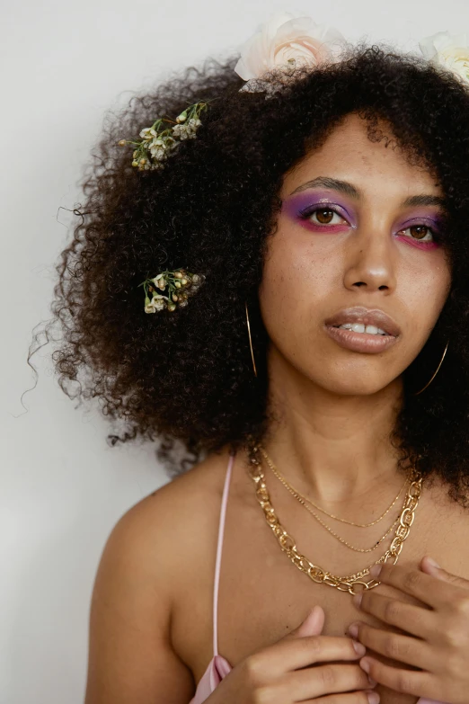 a woman with flowers on her head and earrings