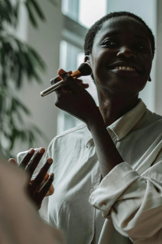 a woman holding a cigarette and smiling at the camera