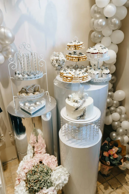 a wedding party is going on with silver and white decor