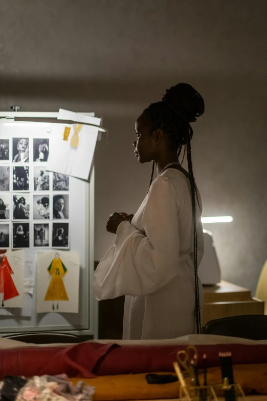 the woman stands by the table with her hands folded