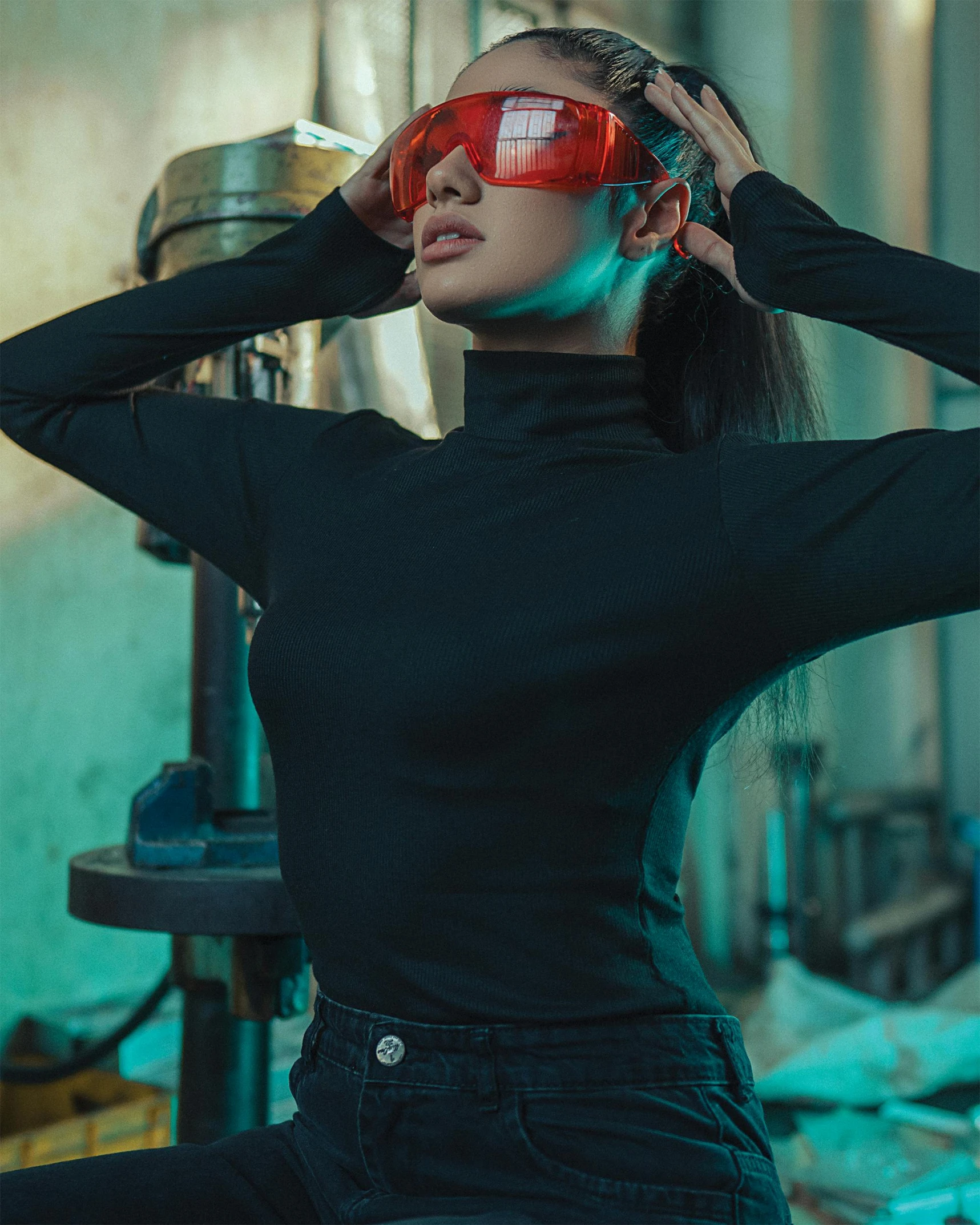 a woman sitting on the floor with red sunglasses on