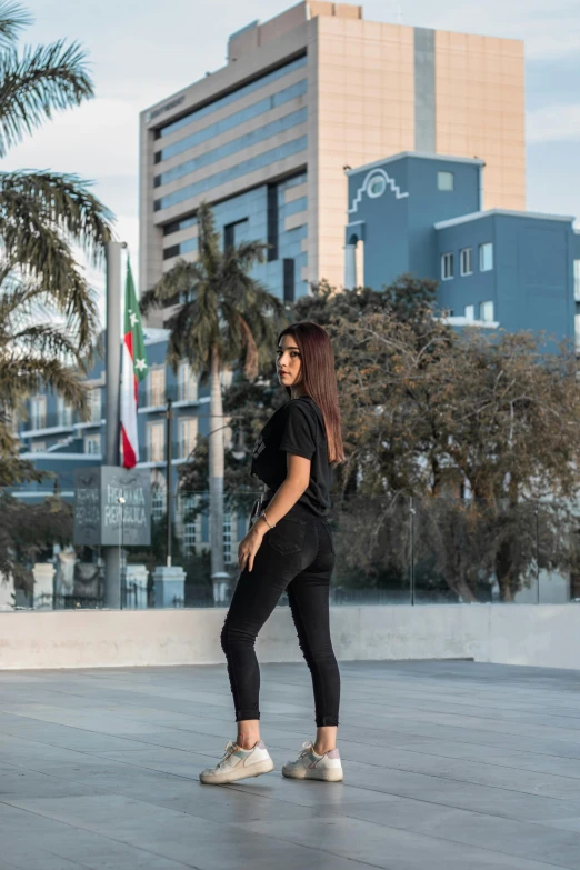 the woman is riding a skateboard on the pavement