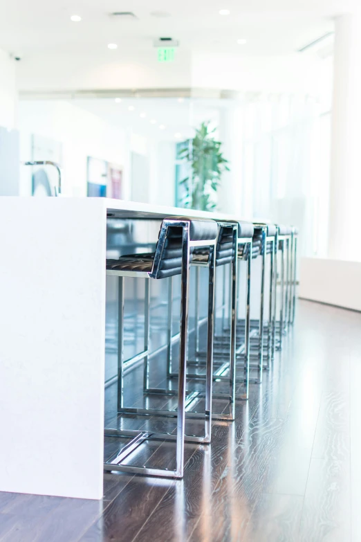 a row of black chairs sitting on top of a hard wood floor