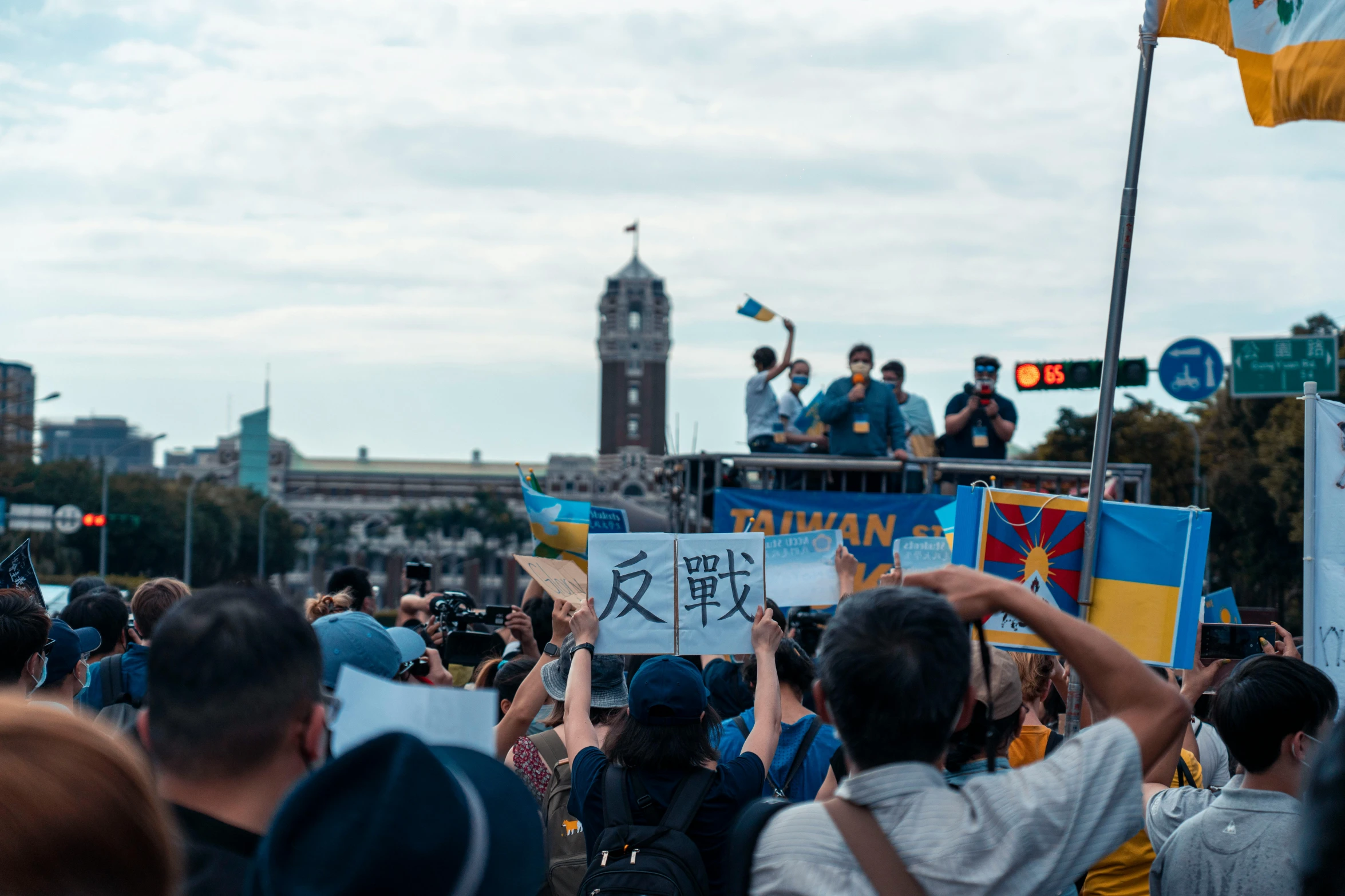 a crowd of people with sign making signs