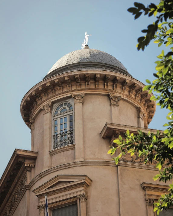 the building's domed top is decorated with statues