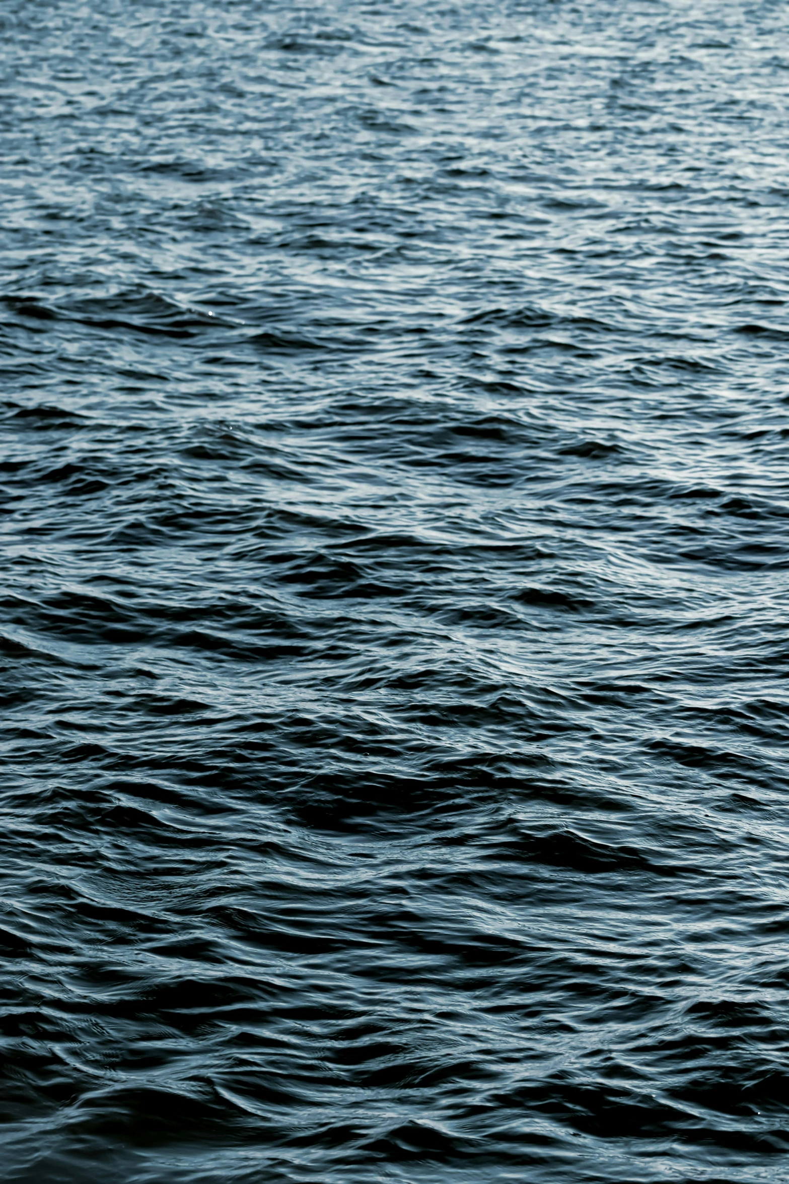 a large body of water with one person on the surfboard