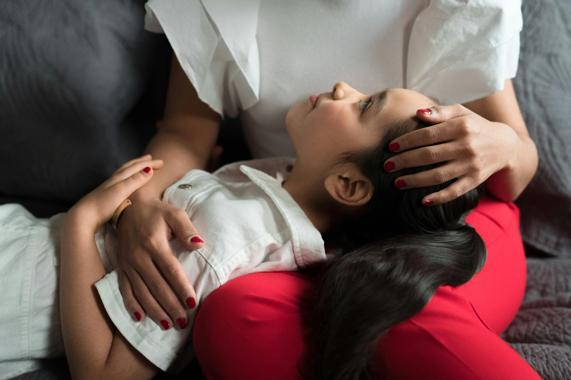 woman with her hand on the head of a baby