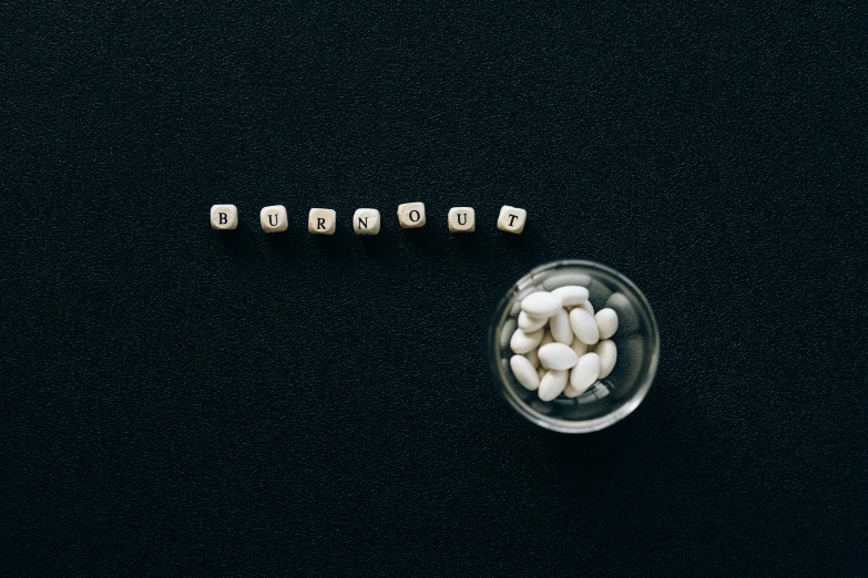 a glass bowl filled with white and black dices