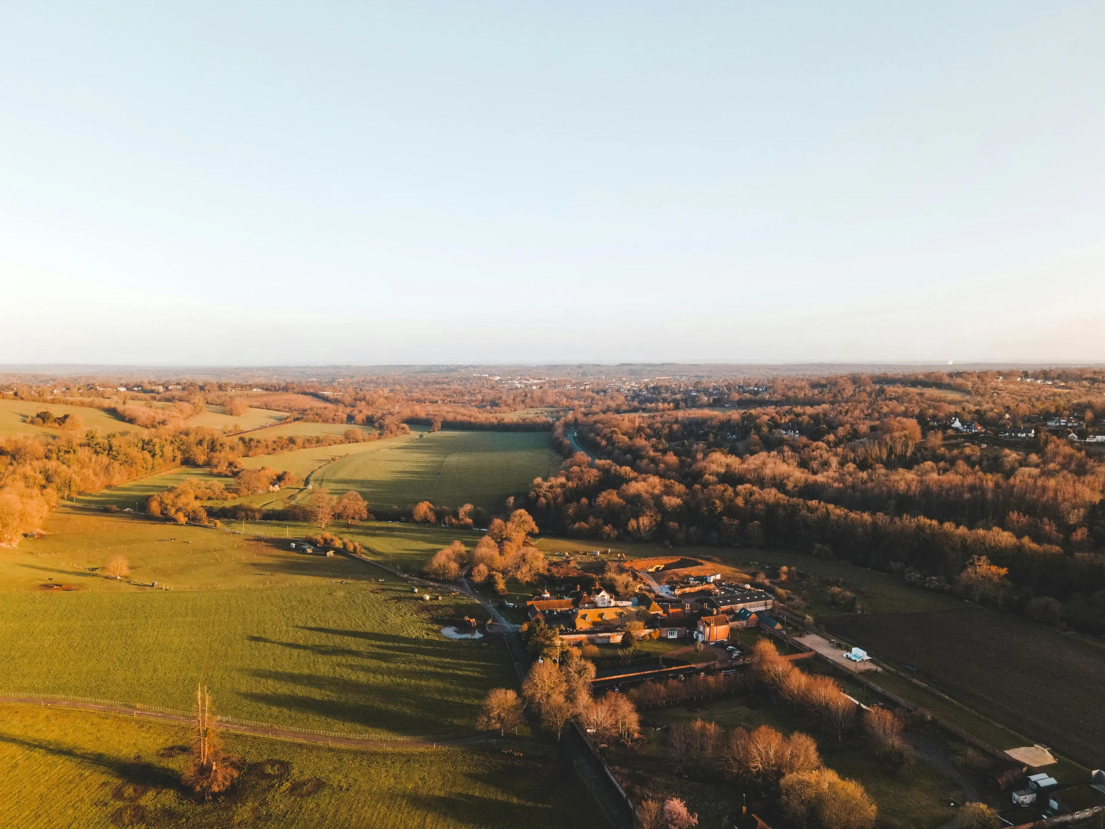 an aerial view of a country house with a lot of trees around