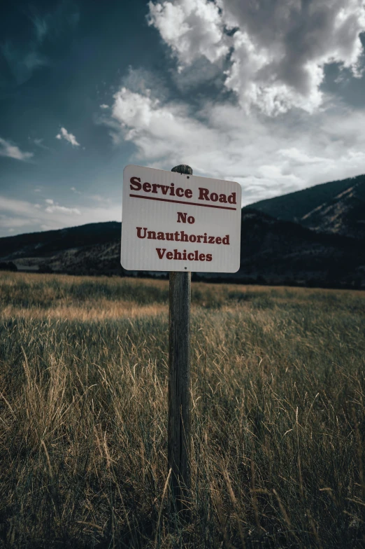 a sign in a field saying the service road is not uninstruct