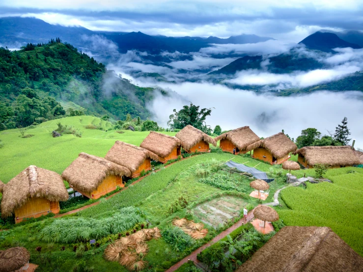 this is an aerial view of a village with a small hill in the distance