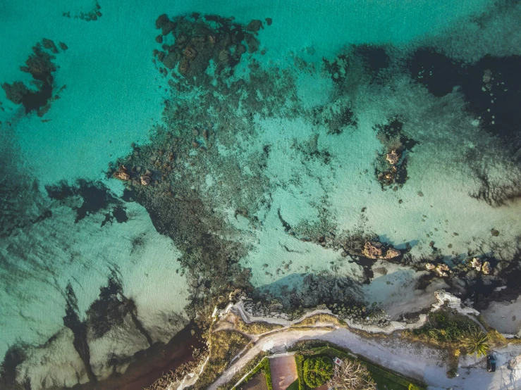 the view from the air shows a white sand beach with a lagoon