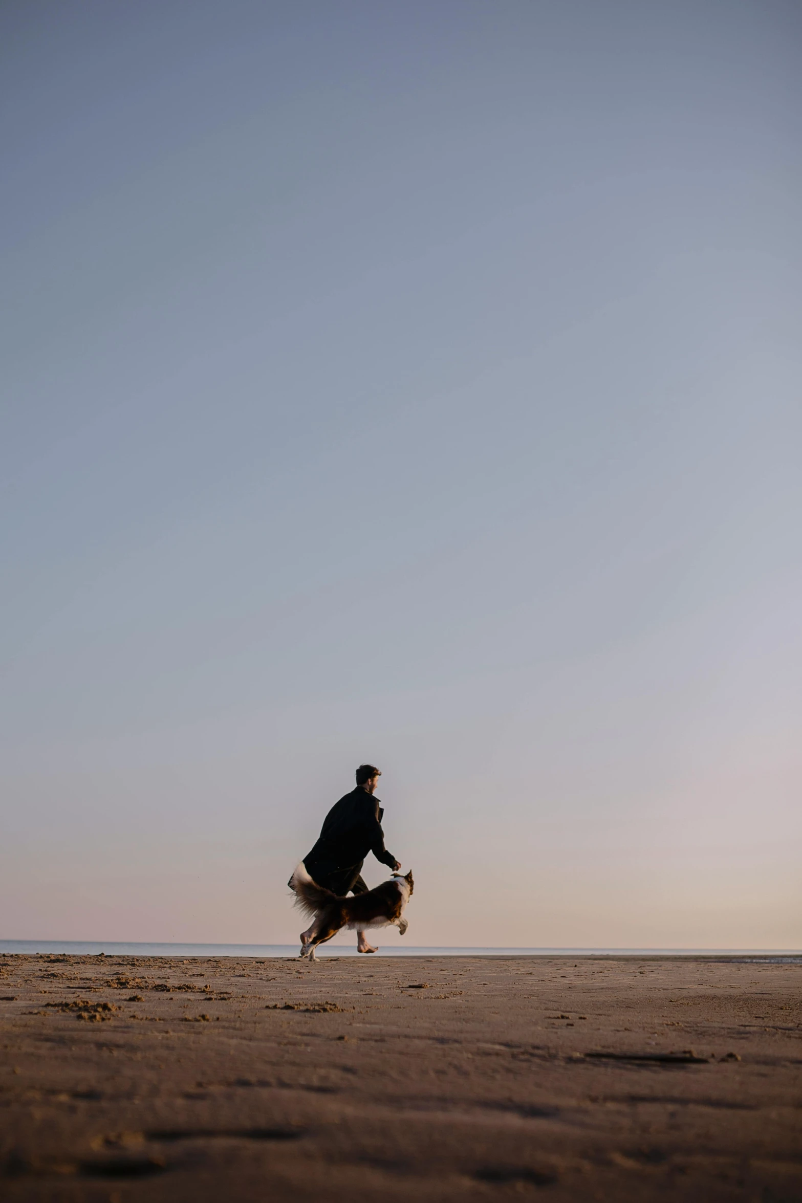 there is a man standing on the beach by himself