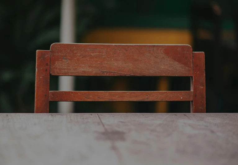 a wooden bench sitting on top of a table